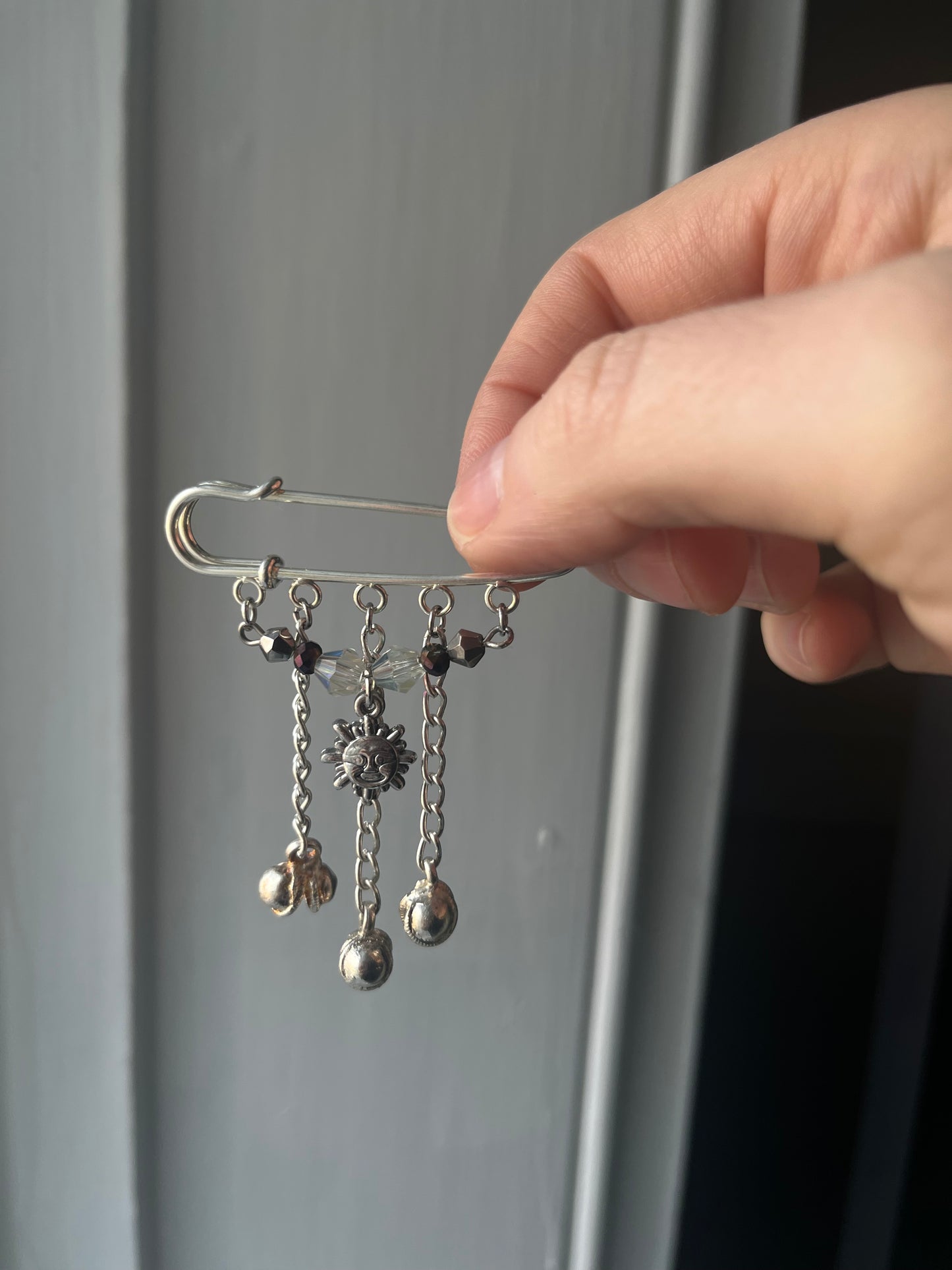 Sun and bells charm pin